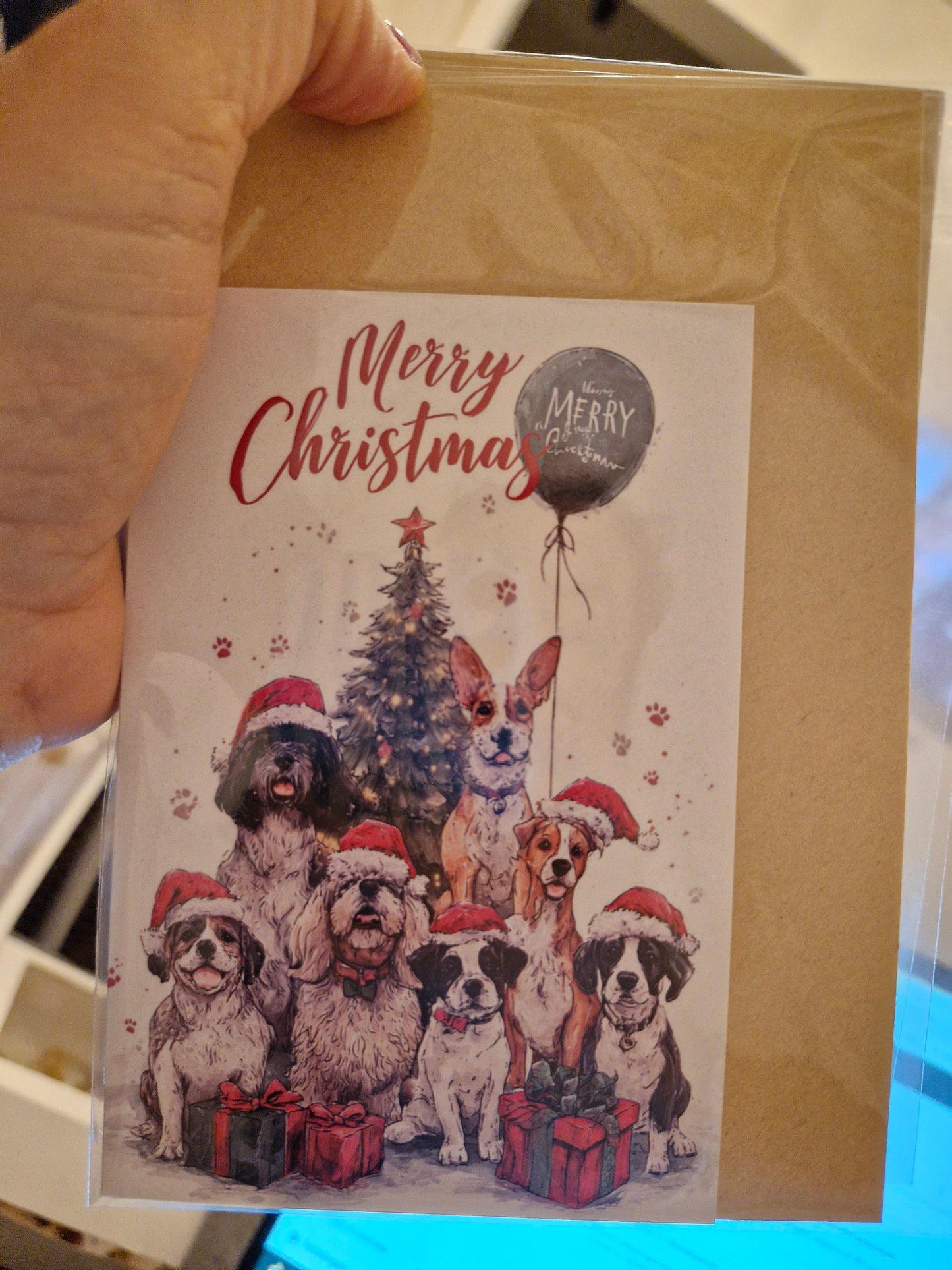 Kerstkaart Merry Christmas met 7 honden en blauwe ballon - A6 wenskaart