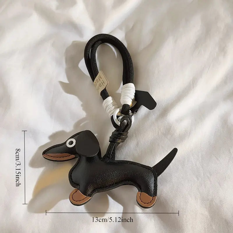 Lederen sleutelhanger of telefoonhanger teckel Black & tan met zwart kort eraan