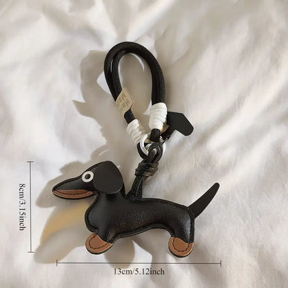 Lederen sleutelhanger of telefoonhanger teckel Black & tan met zwart kort eraan