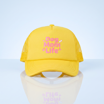 Gele trucker cap 'Dog Mom Life' op blauwe studio-achtergrond voor hondenmama's