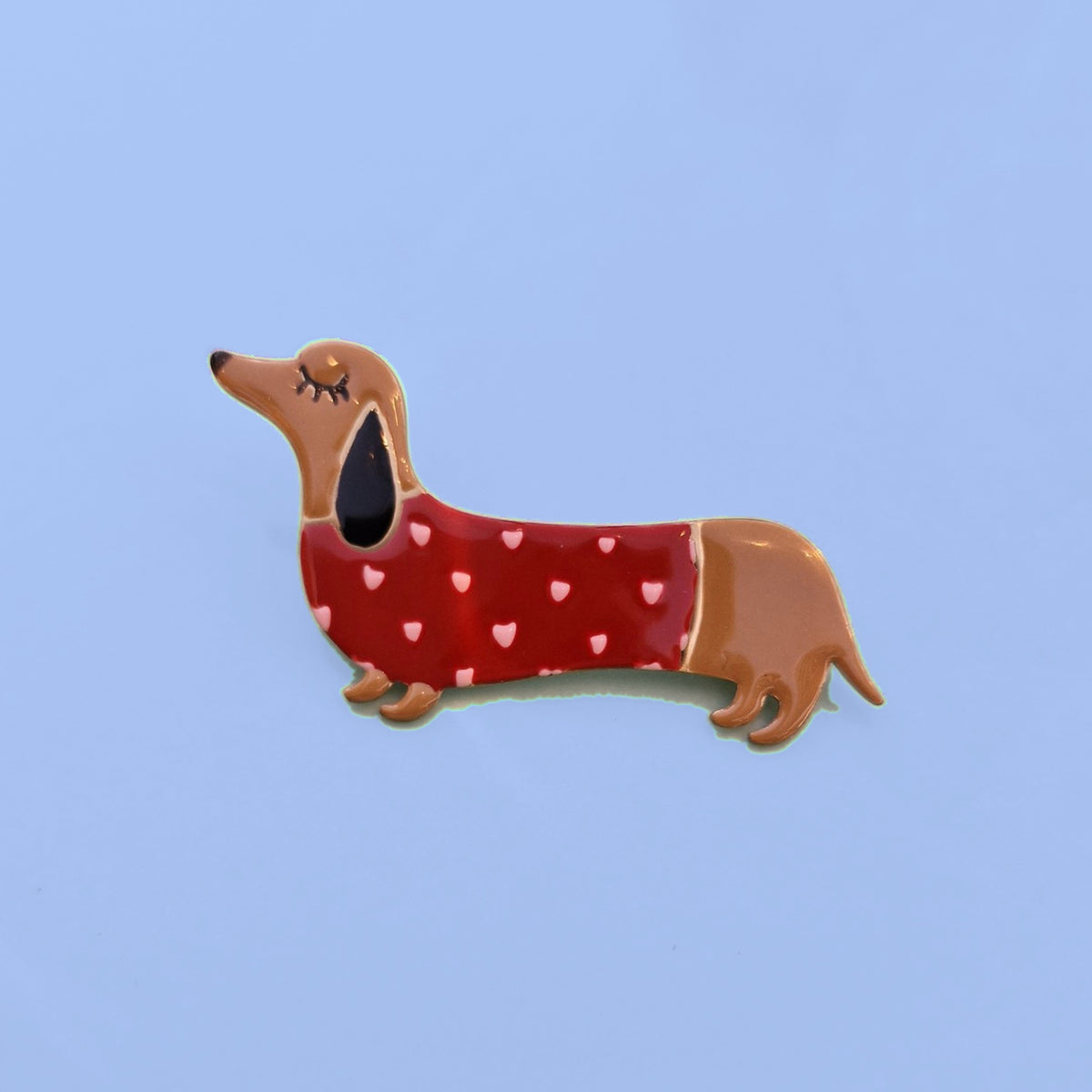 Emaille teckel broche met rood truitje en witte hartjes
